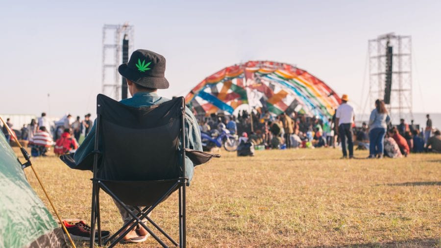 man sitting on a camping chair at a festival