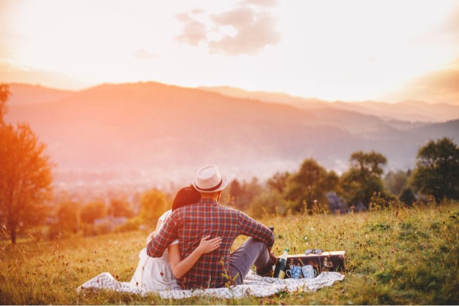 Couple enjoying a romantic sunset picnic