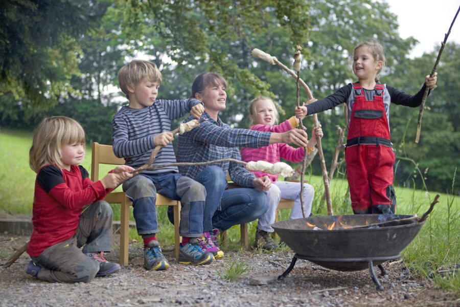 Kids preparing firewood for campfire