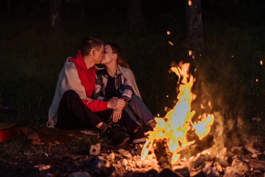 Romantic couple at the campfire and tent