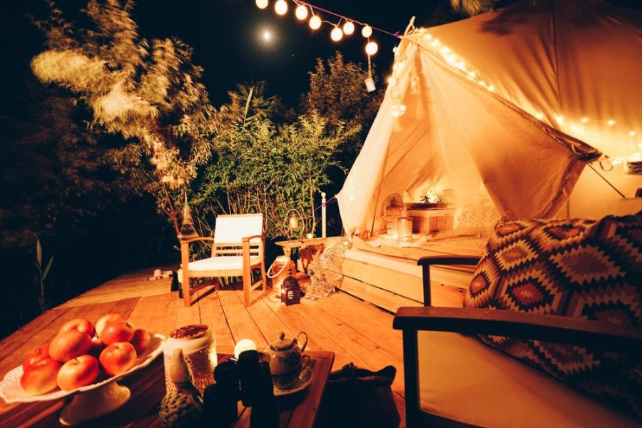 romantic glamping tent with string lights