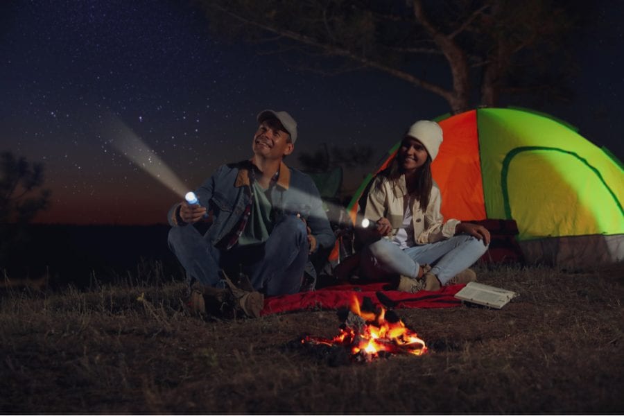 couple with camping flashlights