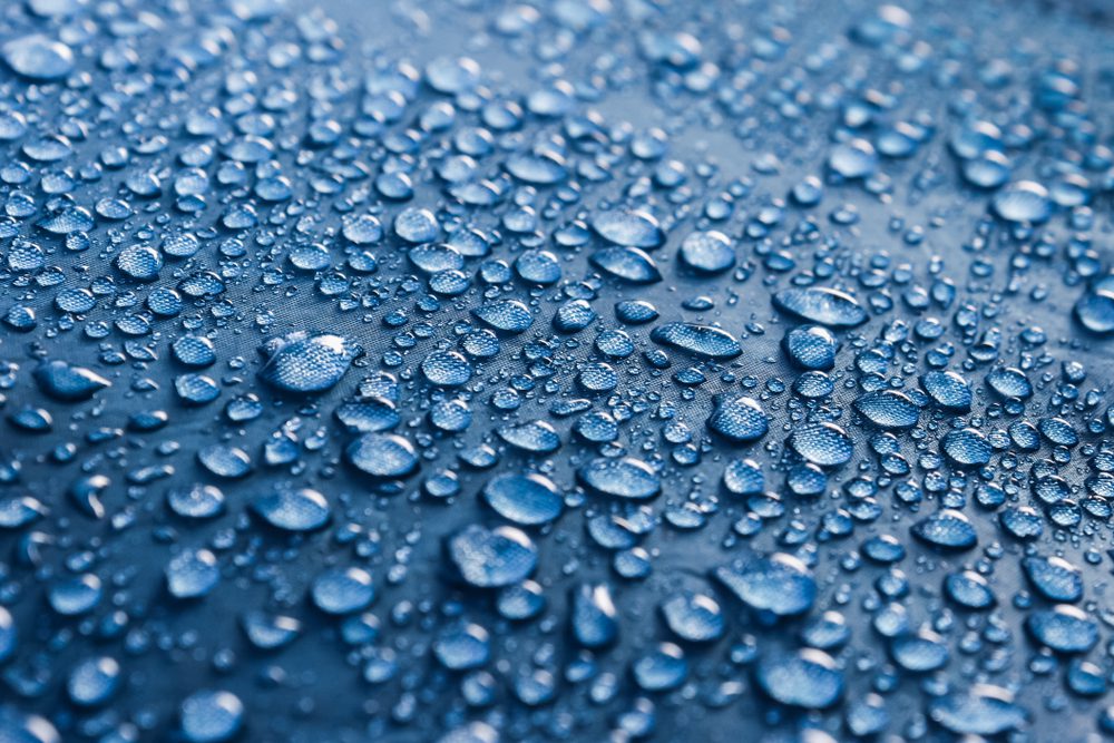 Water,Drops,On,The,Fabric.,Rain,Water,Droplets,On,Blue